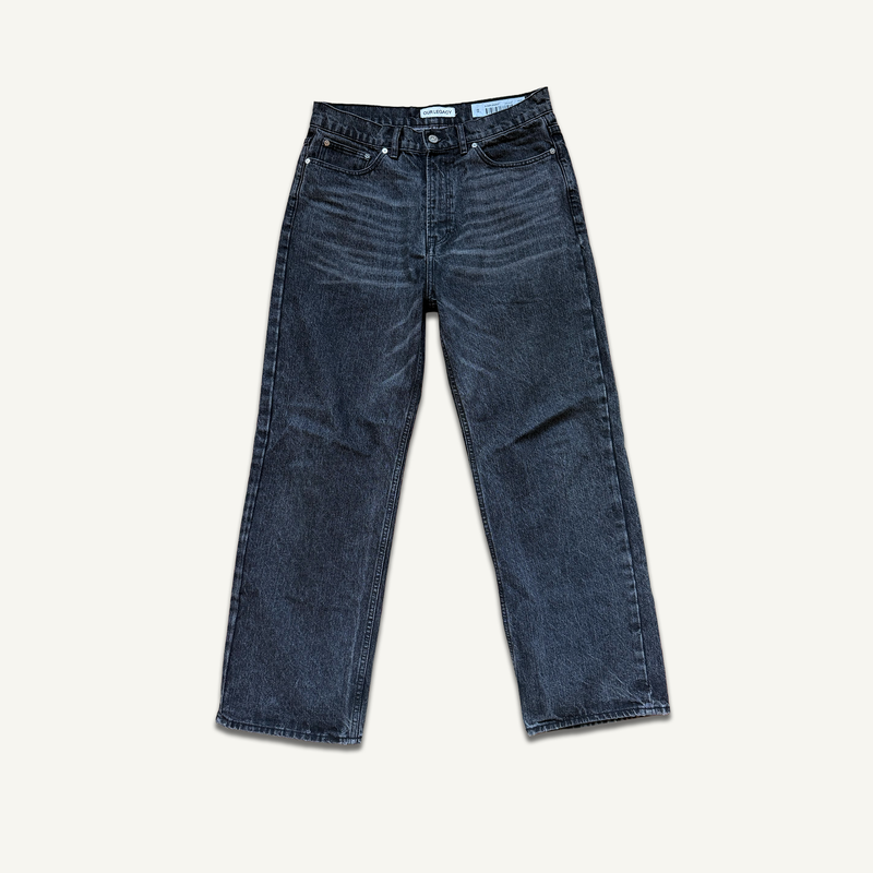 Our Legacy Third Cut jeans in washed black — the Swedish label's signature relaxed denim