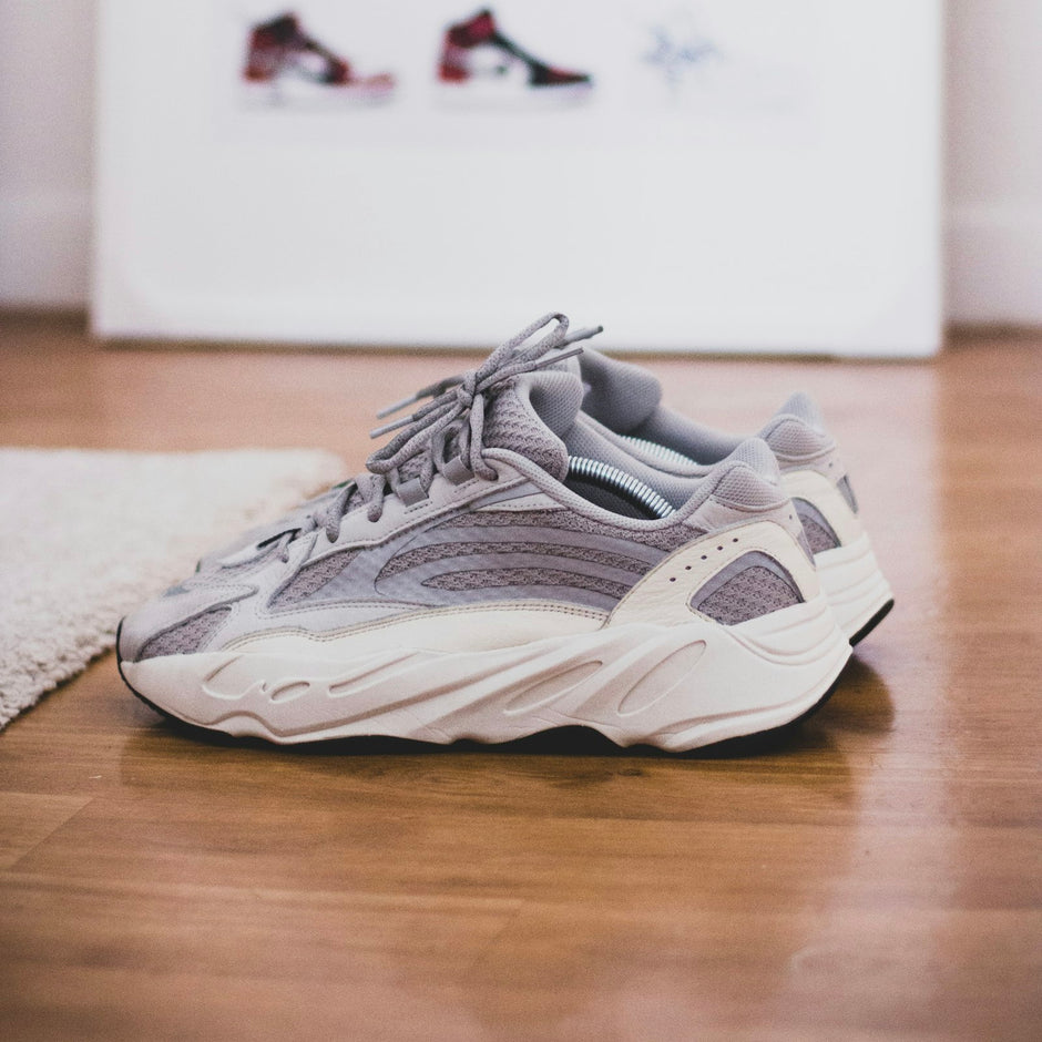 Pair of grey sneakers on a hardwood floor
